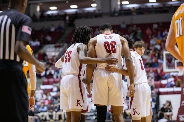 The basketball team huddles together during a game